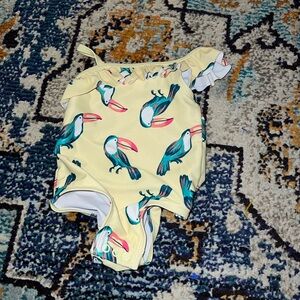 Carters 6/9 one piece pelican print suit. Ruffle accent at chest. VGUC.